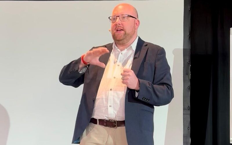 Johann Goree speaking at a business acquisition event